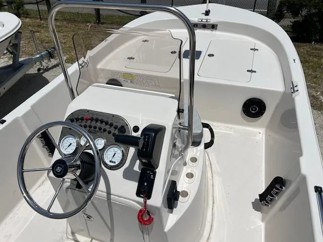 Slide: The Image of 2025 Carolina Skiff 178 JLS boat interior with steering wheel and control panel. - 6
