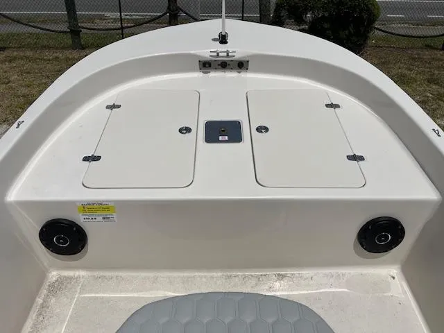 Slide: The Image of 2025 Carolina Skiff 178 JLS boat deck with storage compartments and speakers. - 8