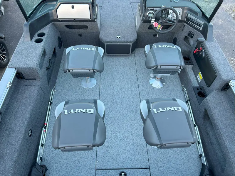 Slide: The Image of 2025 Lund 2075 IMPACT XS boat interior with four branded seats and modern dashboard. - 3
