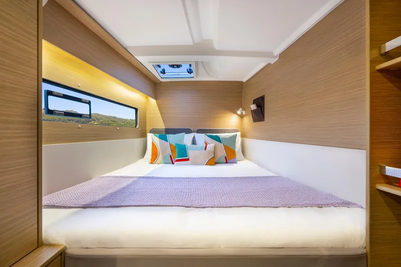 Slide: The Image of Luxurious cabin interior of 2025 Lagoon 38 yacht with modern bedding and natural light. - 42