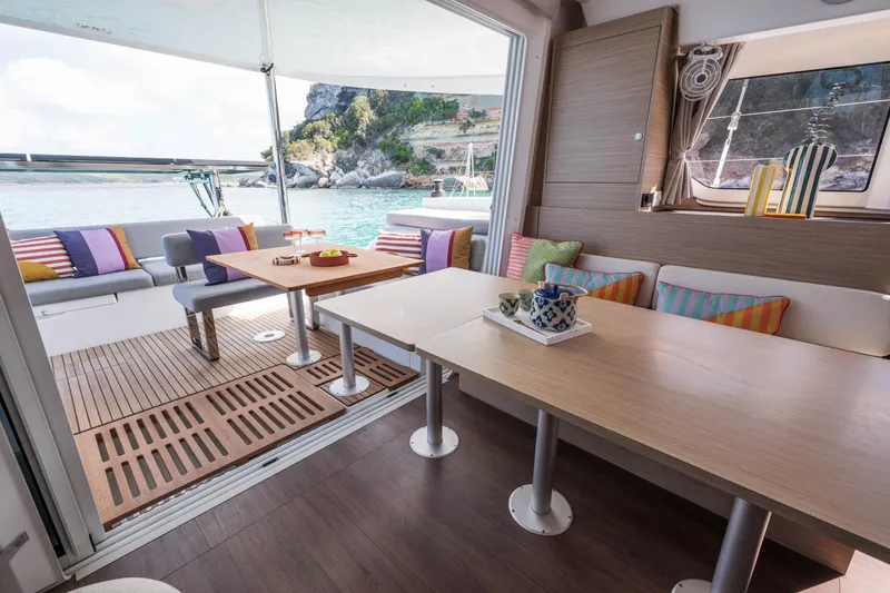 Slide: The Image of Luxurious interior of 2025 Lagoon 38 catamaran with colorful cushions and scenic ocean view. - 48