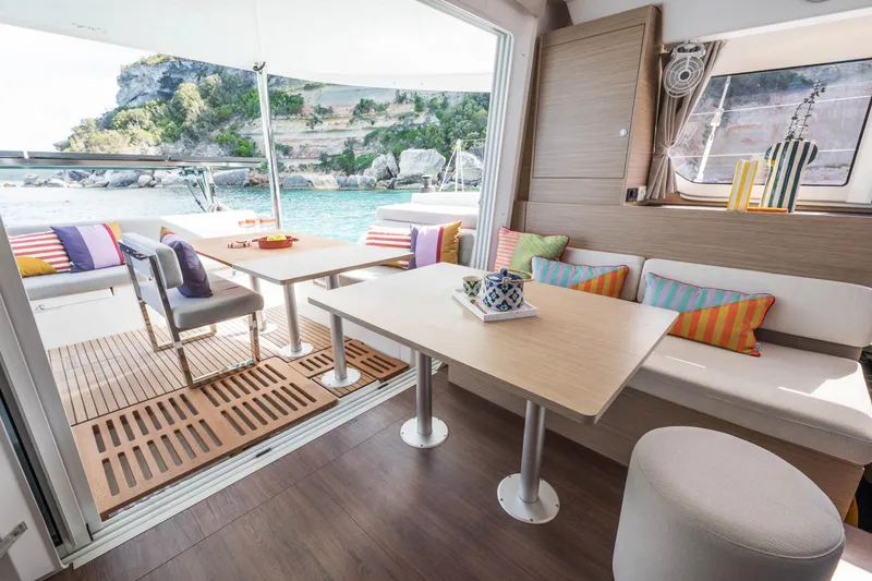 Slide: The Image of Luxurious interior of 2025 Lagoon 38 catamaran with colorful cushions and scenic ocean view. - 50