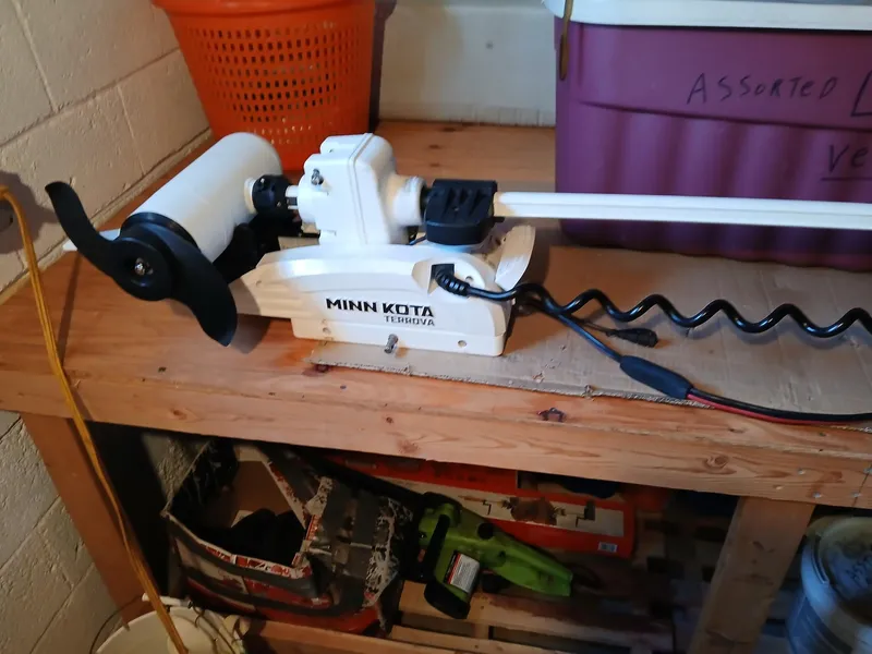 Slide: The Image of Minn Kota trolling motor on wooden bench, suitable for 2001 Angler 22 Center Console. - 13