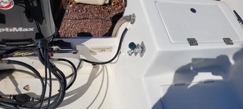 Slide: The Image of 2001 Angler 22 Center Console boat deck with engine cables and storage compartment. - 15