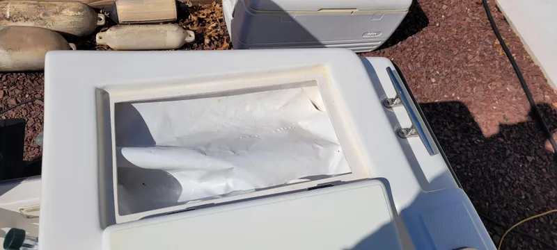 Slide: The Image of Open storage compartment on a 2001 Angler 22 Center Console boat. - 19