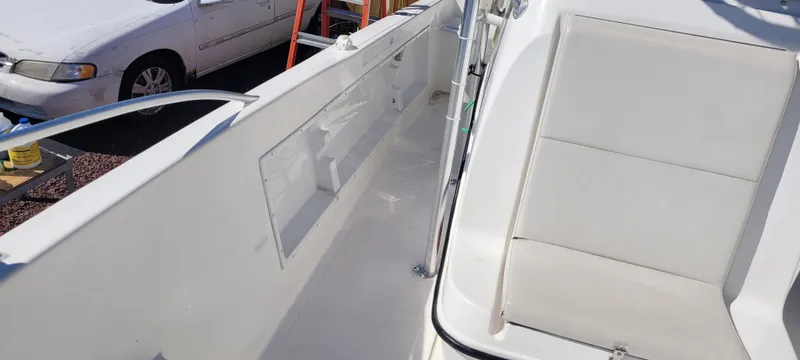 Slide: The Image of 2001 Angler 22 Center Console boat interior with seating and storage compartments. - 25