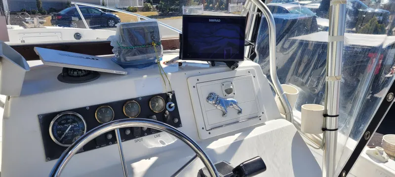 Slide: The Image of Center console of 2001 Angler 22 boat with steering wheel and navigation equipment. - 6