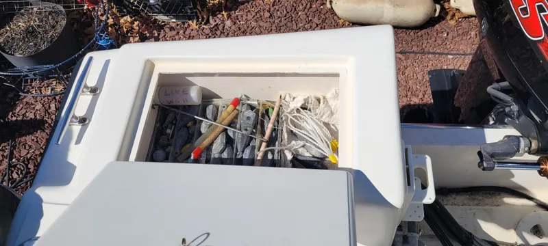 Slide: The Image of Storage compartment on a 2001 Angler 22 Center Console boat with fishing gear. - 16