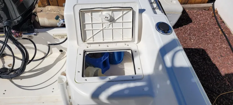 Slide: The Image of Open storage compartment on a 2001 Angler 22 Center Console boat. - 17