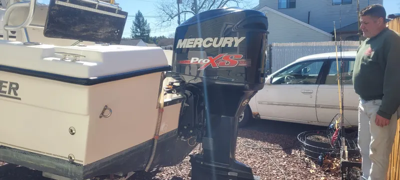 Slide: The Image of 2001 Angler 22 Center Console with Mercury Pro XS outboard motor in a driveway. - 2