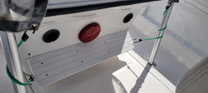 Slide: The Image of 2001 Angler 22 Center Console boat interior with seating and support poles. - 21