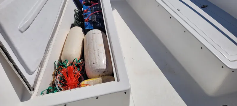 Slide: The Image of Storage compartment on 2001 Angler 22 Center Console boat with marine equipment. - 8