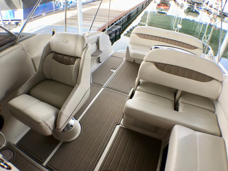 Slide: The Image of 2001 Regal 2660 Commodore boat interior with beige seating and wood-style flooring. - 10