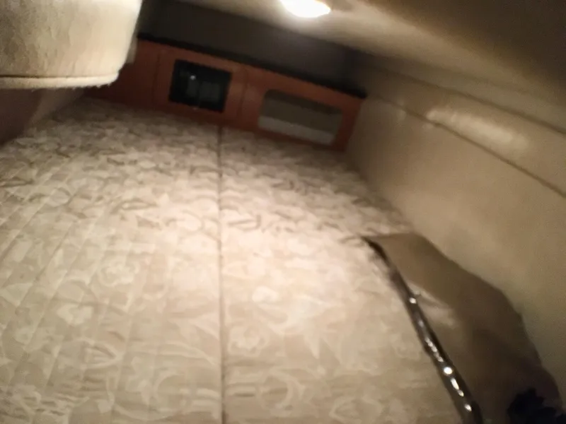 Slide: The Image of 2001 Regal 2660 Commodore cabin interior with bed and storage area. - 15
