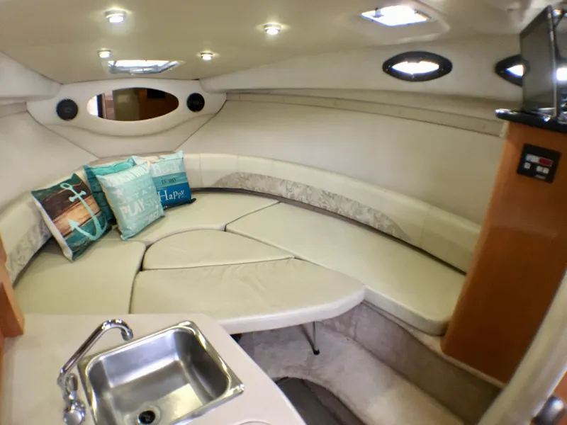 Slide: The Image of Interior of 2001 Regal 2660 COMMODORE boat with cozy seating and kitchenette. - 17