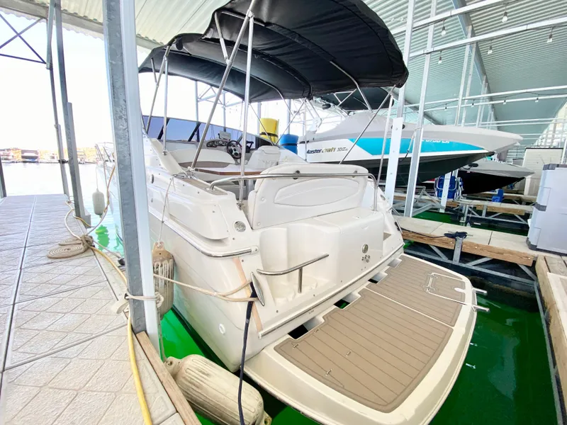 Slide: The Image of 2001 Regal 2660 Commodore boat docked under a canopy, rear view. - 3