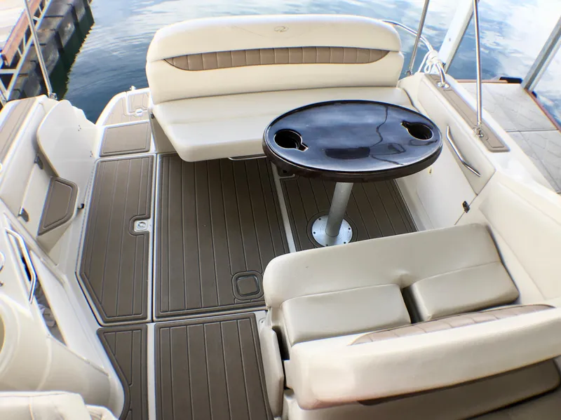 Slide: The Image of 2001 Regal 2660 Commodore boat interior with seating and table on deck. - 4