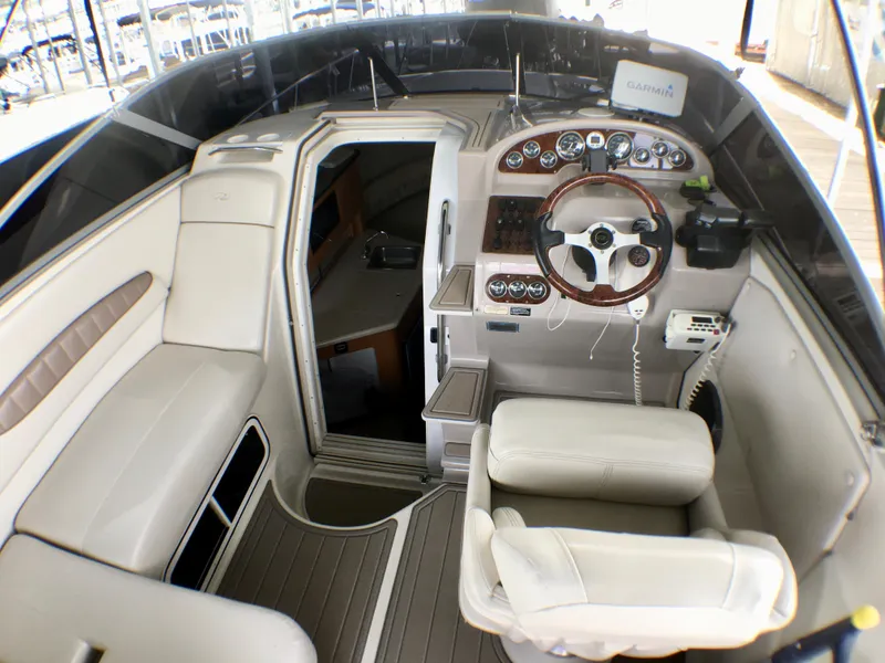 Slide: The Image of Interior of 2001 Regal 2660 COMMODORE boat with steering wheel and seating area. - 6
