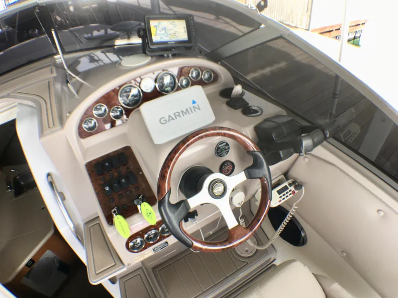 Slide: The Image of Cockpit of 2001 Regal 2660 COMMODORE with Garmin navigation system and wood-trimmed steering wheel. - 8