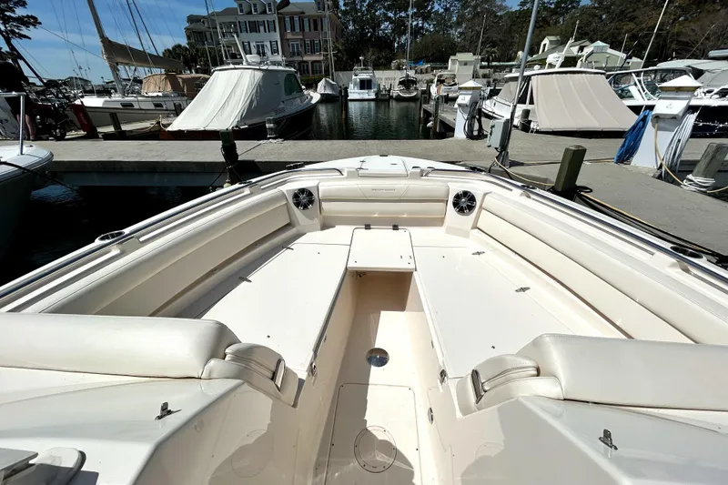 Slide: The Image of 2020 Grady-White Freedom 325 boat interior at marina, showcasing spacious seating and sleek design. - 13