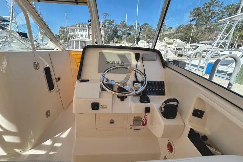 Slide: The Image of 2020 Grady-White Freedom 325 helm with Garmin navigation system and steering wheel. - 15