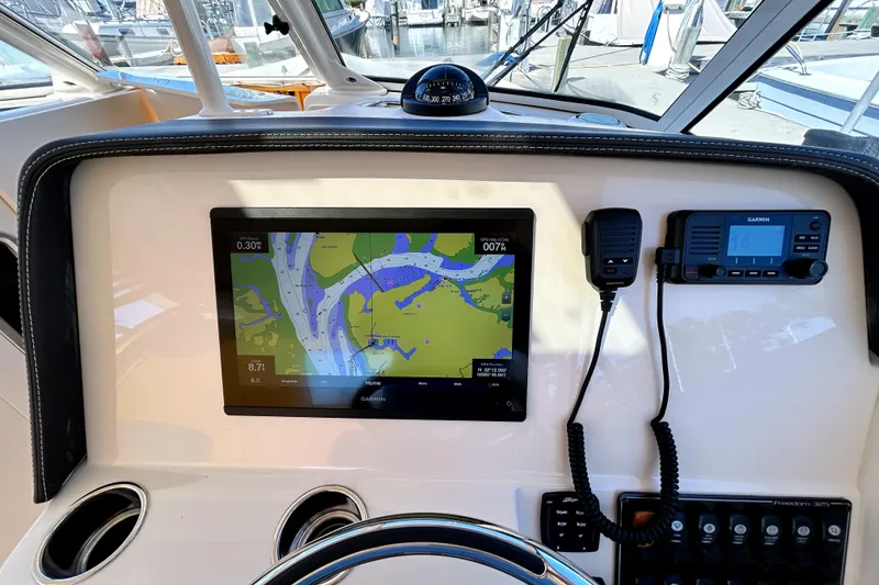 Slide: The Image of Dashboard of 2020 Grady-White Freedom 325 with navigation and communication equipment. - 16