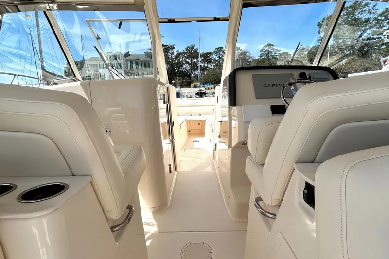 Slide: The Image of 2020 Grady-White Freedom 325 boat interior with plush seating and modern dashboard. - 19