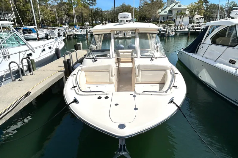Slide: The Image of 2020 Grady-White Freedom 325 boat docked in a marina, front view. - 2