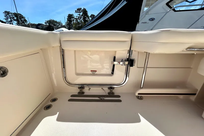 Slide: The Image of 2020 Grady-White Freedom 325 boat interior with seating and storage compartment. - 20
