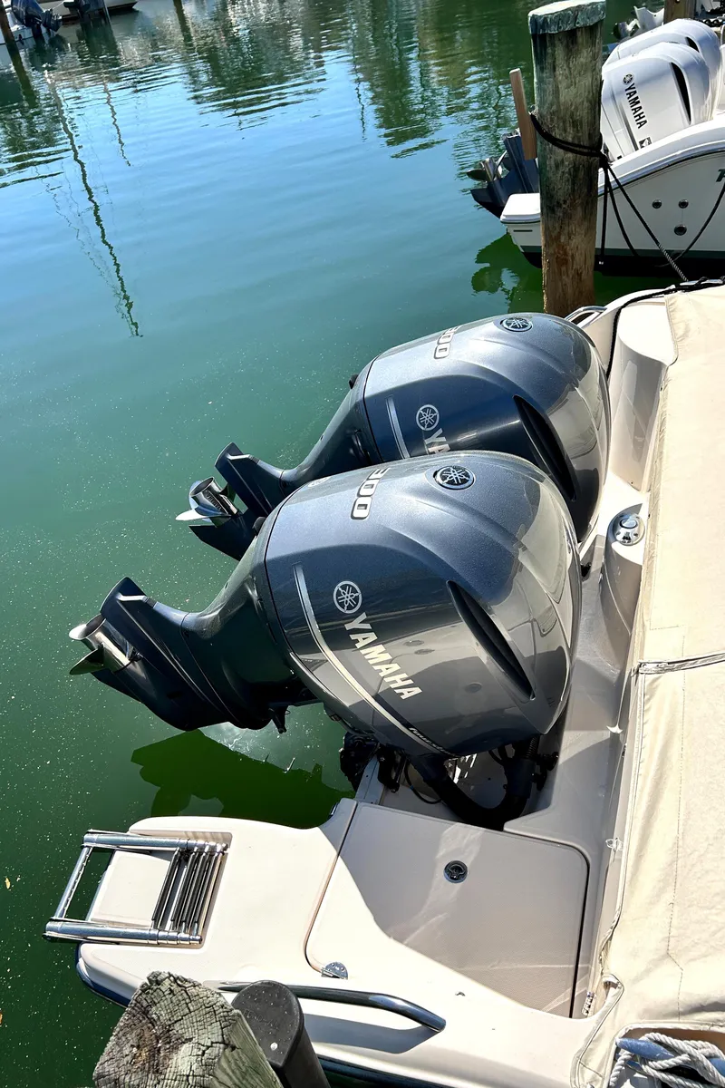 Slide: The Image of 2020 Grady-White Freedom 325 with twin Yamaha outboard motors docked in marina. - 21