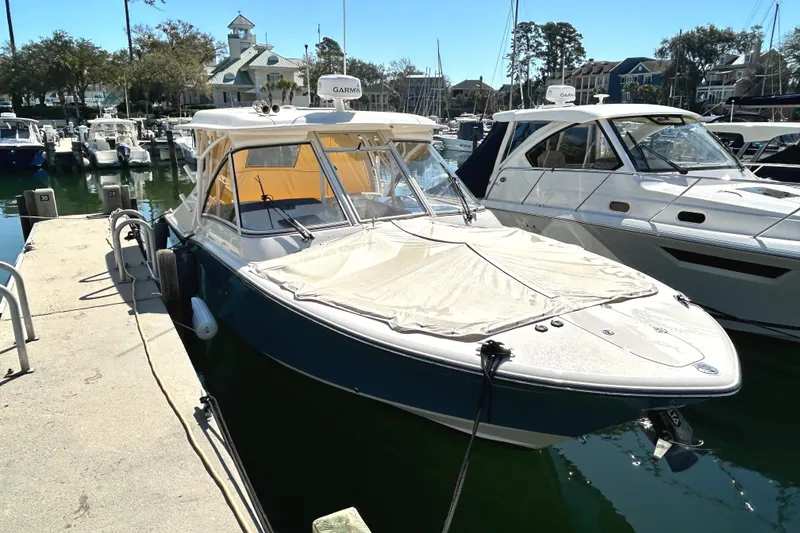 Slide: The Image of 2020 Grady-White Freedom 325 boat docked at a marina on a sunny day. - 5