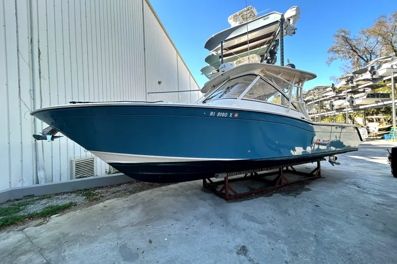Slide: The Image of 2020 Grady-White Freedom 325 boat in storage, blue hull, side view. - 7
