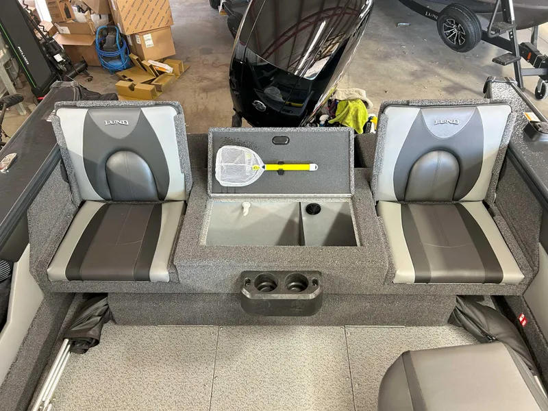 Slide: The Image of 2025 Lund 1875 Crossover XS boat interior with seating and storage compartments. - 7