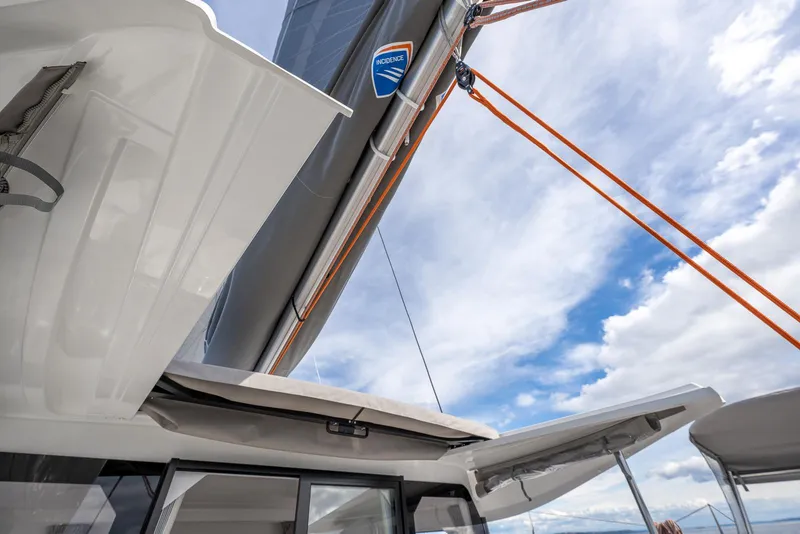 Slide: The Image of Sailing yacht Excess 11, 2025 model, with open hatches and vibrant sky background. - 12