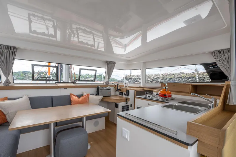 Slide: The Image of Modern interior of 2025 Excess 11 catamaran with kitchen and seating area. - 20