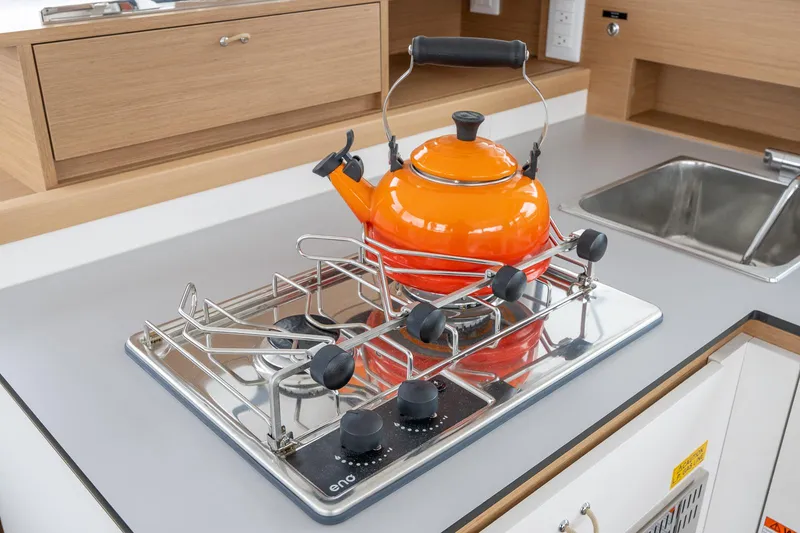 Slide: The Image of Orange kettle on a modern stove in a 2025 Excess 11 kitchen. - 22