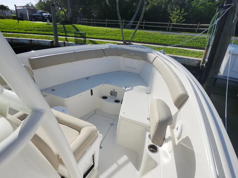 Slide: The Image of 2018 Sailfish 270 CC boat interior with cushioned seating and storage compartments. - 12