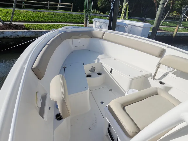 Slide: The Image of 2018 Sailfish 270 CC boat interior with cushioned seating and storage compartments. - 13