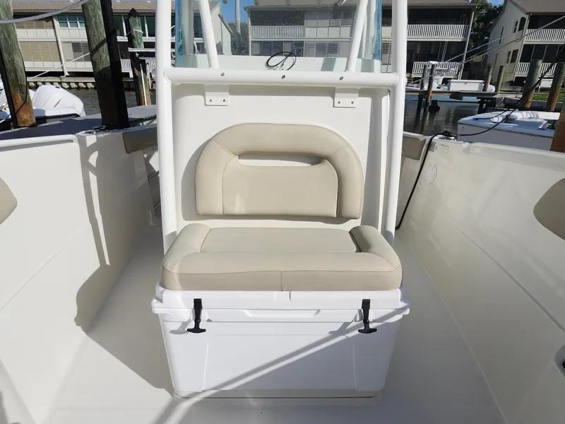 Slide: The Image of 2018 Sailfish 270 CC boat interior with cushioned seating and storage. - 14