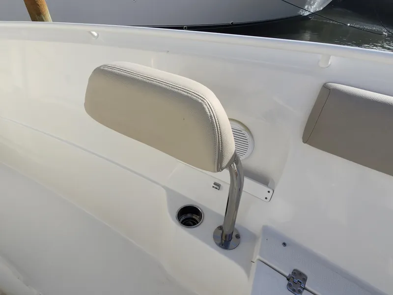 Slide: The Image of 2018 Sailfish 270 CC boat interior with beige seating and speaker detail. - 16