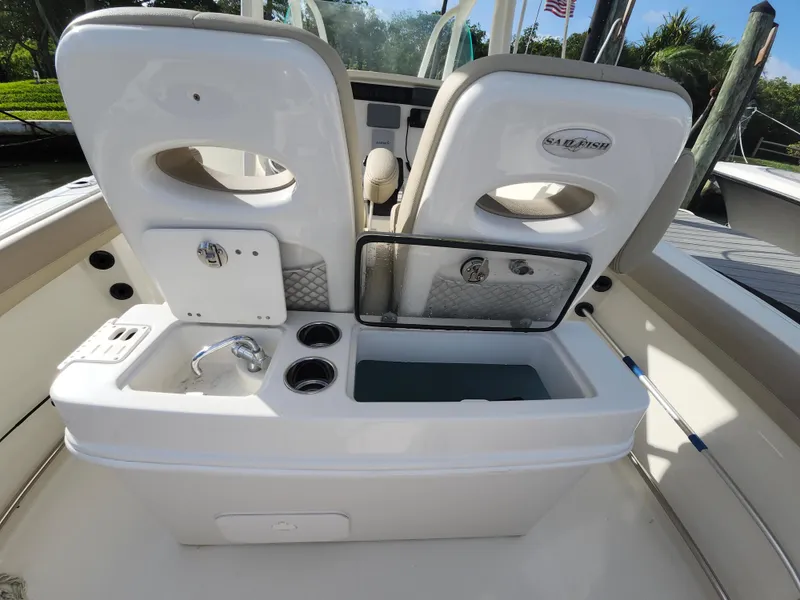 Slide: The Image of 2018 Sailfish 270 CC boat interior with sink and storage compartments. - 19