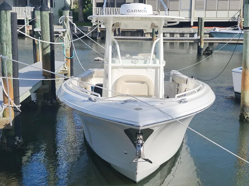 Slide: The Image of 2018 Sailfish 270 CC boat docked in marina, featuring Garmin equipment. - 4