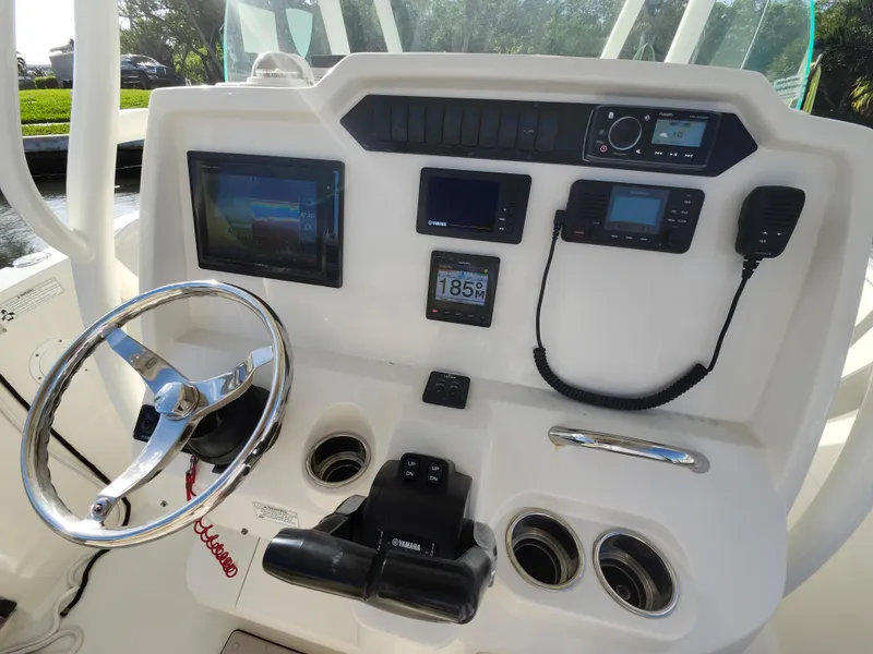 Slide: The Image of 2018 Sailfish 270 CC boat dashboard with steering wheel and electronic controls. - 9