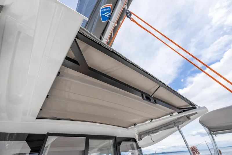 Slide: The Image of 2025 Excess 11 yacht with open sunroof, showcasing modern design and blue sky background. - 13