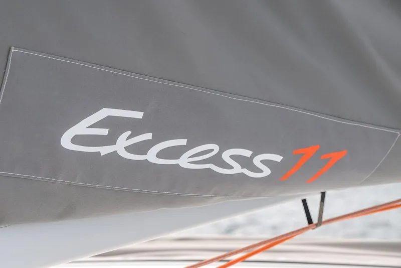 Slide: The Image of Excess 11 sailboat logo on gray fabric, 2025 model. - 18
