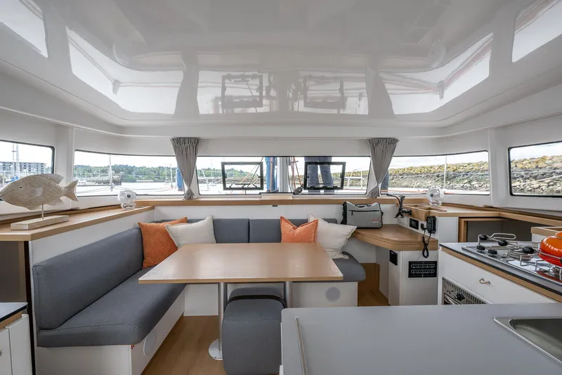 Slide: The Image of Modern interior of 2025 Excess 11 catamaran with cozy seating and kitchen area. - 19