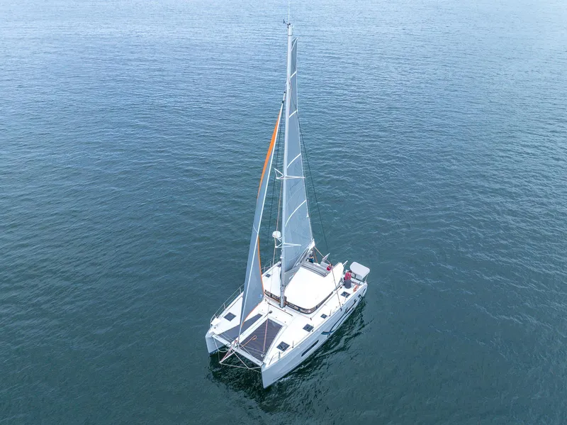 Slide: The Image of 2025 Excess 11 catamaran sailing on calm blue waters. - 5