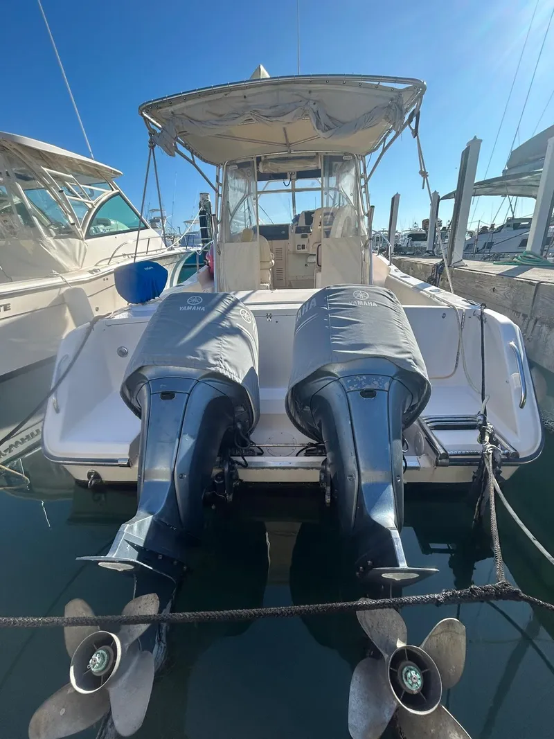 Slide: The Image of 2005 Grady-White Marlin 300 boat with twin outboard motors docked at marina. - 3