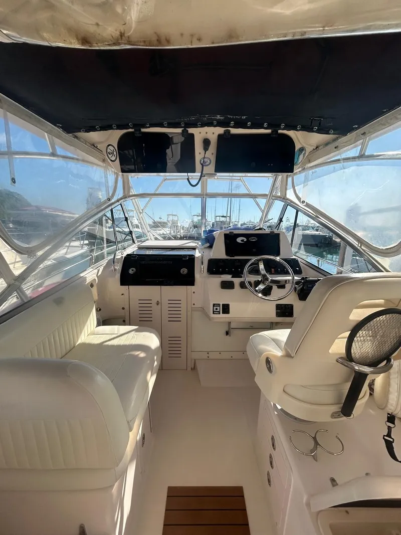 Slide: The Image of 2005 Grady-White Marlin 300 boat interior with helm, seating, and steering wheel. - 4