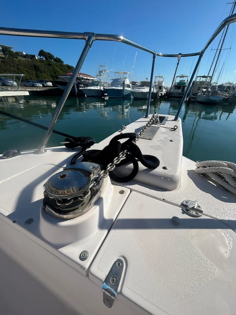 Slide: The Image of 2005 Grady-White Marlin 300 boat docked, showcasing anchor and deck details. - 8